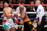 Floyd Mayweather, center, delivers a knockout punch to Victor Ortiz as referee Joe Cortez, right, looks on in the fourth round during a WBC welterweight title fight, Saturday, Sept. 17, 2011, in Las Vegas